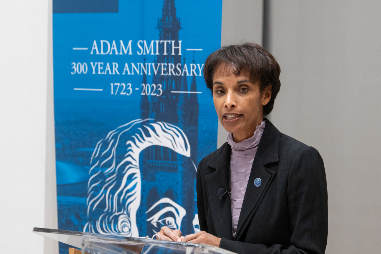 Cecilia talking at podium with a Adam Smith 300 poster behind her Source: Charlotte Morris