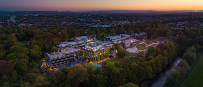 Aerial image of the CVR on the Garscube campus. Sky shows a bright sunset. Site composed of several different buildings. 