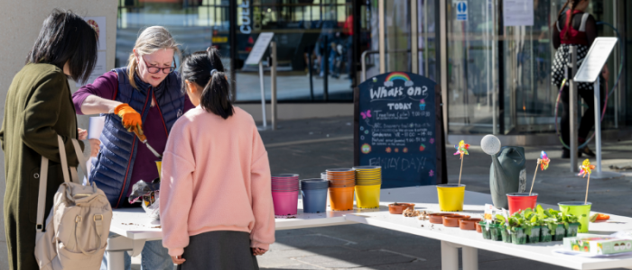 Visitors attend a flower stand outside the ARC