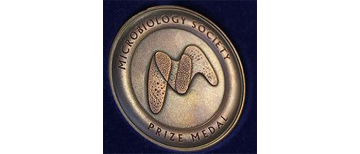 Close up image of a bronze Microbiology Society Medal