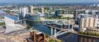 Aerial view of Salford Quays with landmarks including the Millennium Bridge, Lowry Centre and MediaCity UK at Salford Quays, Manchester.