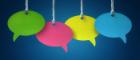 Blank colourful speech bubbles hanging from a cord over blue background