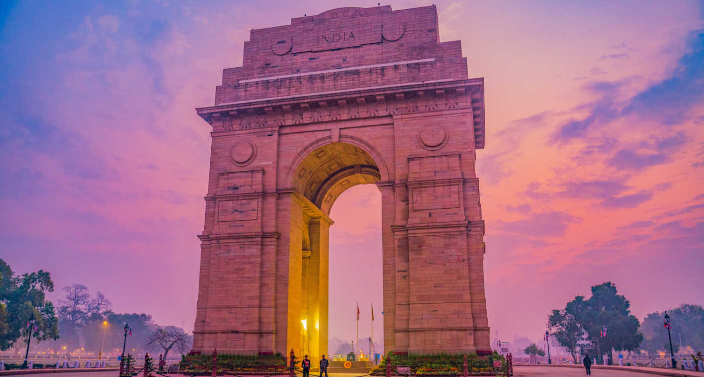 The India Gate arch monument with pink sky in the background [Photo: Shalender Kumar, Unsplash]