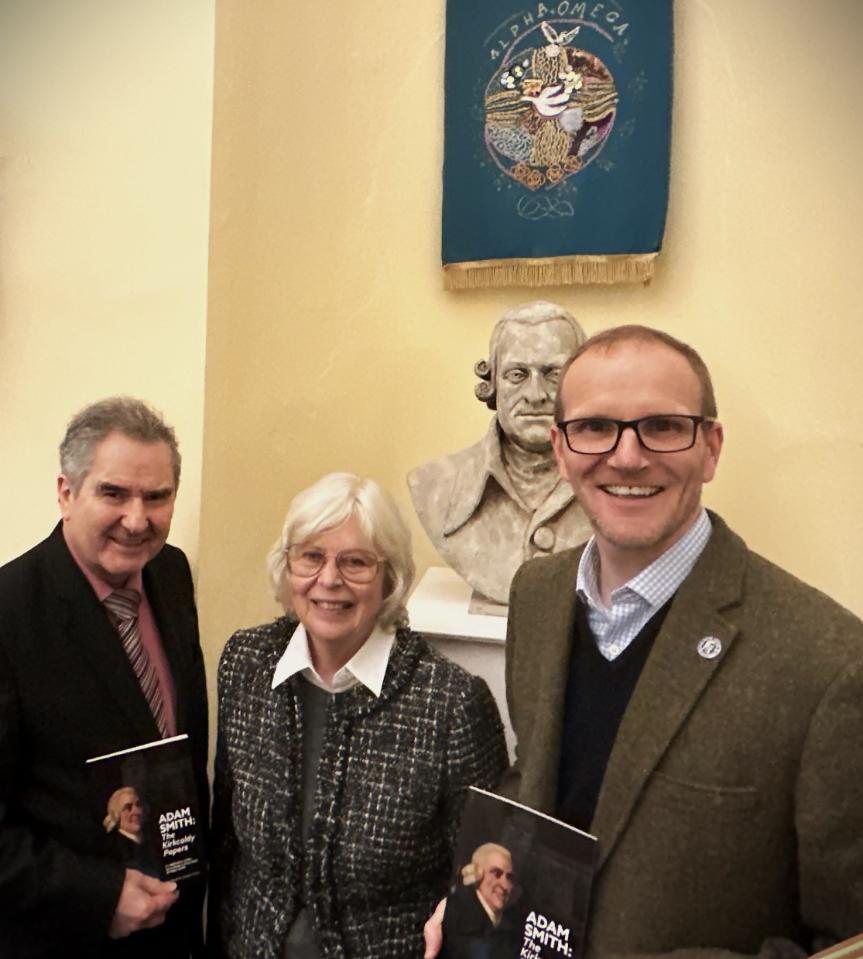 Graeme Roy and two other standing with a bust of Adam Smith behind them Source: Amy Laux