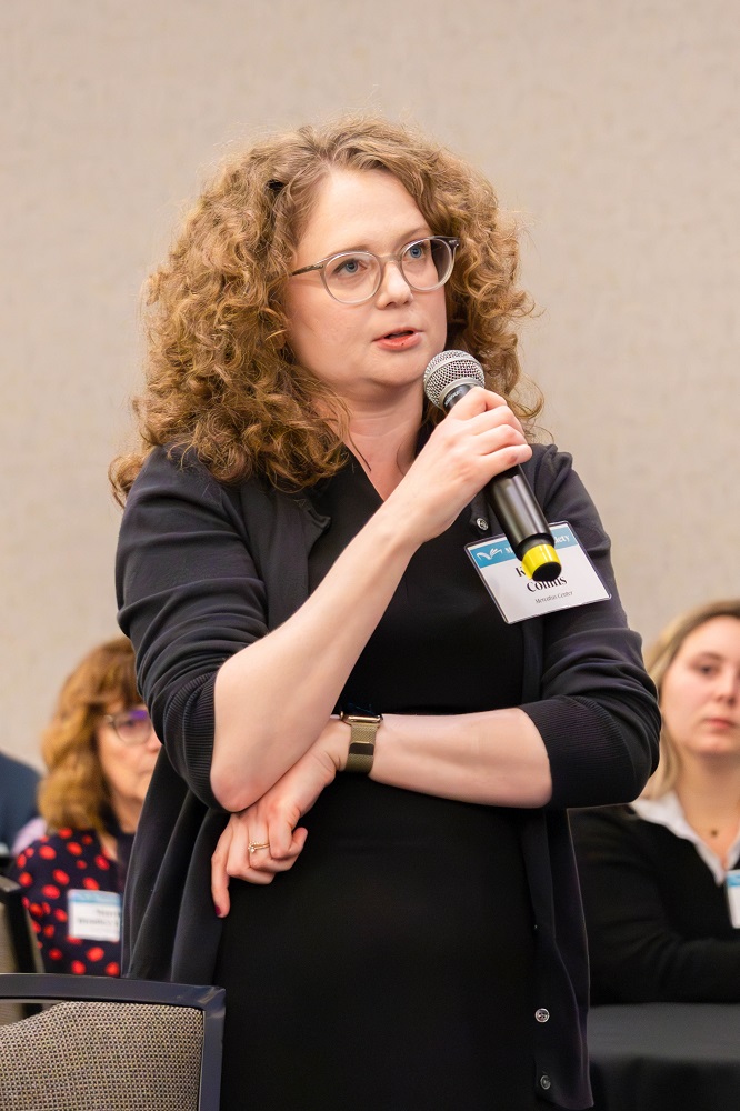 Audience asking a question at the Emma Rothchild event holding a microphone. Source: Amy Laux