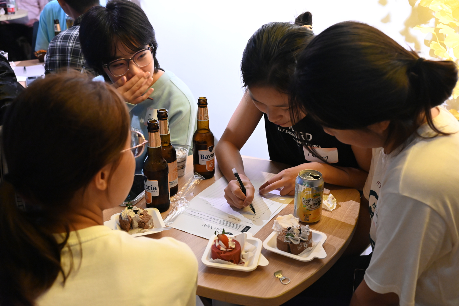 A team of female players enjoy playing the pub quiz at Hainan's Halloween event