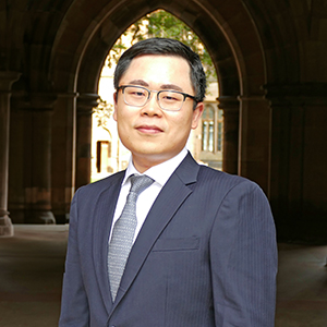 Dr Hangyuan Shi, Lecturer in Accounting, standing in the cloisters, University of Glasgow