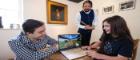 In the kitchen of Robert Burns Ellisland Farm: Left to right Bailey Hodgson, the University of Glasgow Minecraft Society’s President; Rhona Keenan, 11, from Dumfries using the Minecraft Ellisland game while been looked on by Richie Keenan, her father, dressed as Robert Burns, with a portrait of the poet in the background. Photo Credit Martin Shields