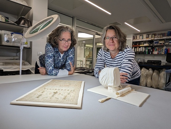 Karen Thompson and Sarah Foskett of the Kelvin Centre for Conservation Research and Cultural Heritage examine some of the restored artefacts