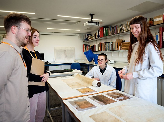 An image of students from the Kelvin Centre for Conservation Research and Cultural Heritage examine some of the restored artefacts