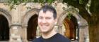 Andrew Buchan standing in the West Quadrangle, University of Glasgow