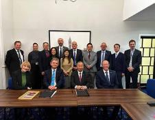 Image of Professor Anton Muscatelli, Professor Christopher Loughrey and members of CityU with signed documents