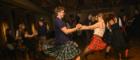 man and woman dancing at a ceilidh