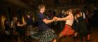 man and woman dancing at a ceilidh