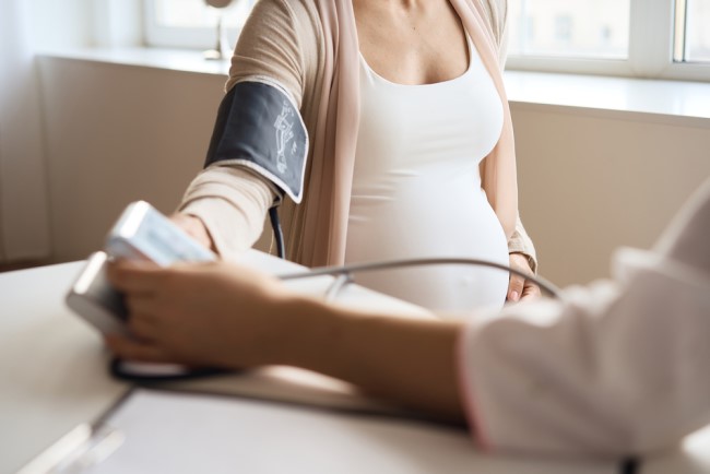 Image of a pregnant person being checked for preeclampsia