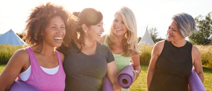 A group of four mature women chatting and walking