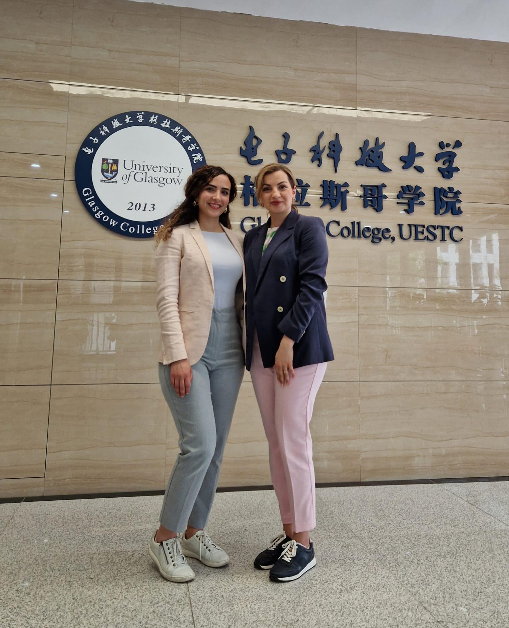 Dr Hanaa Abumarshoud and Dr Lina Mohjazi stand in the lobby of a building at Glasgow College, UESTC in Chengdu (China)
