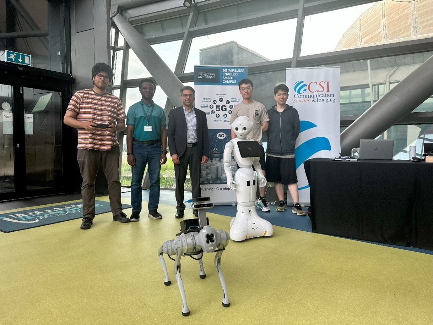 CSI group research team test Robbie the RoboDog at the SEC. The Social Robot also looking on.