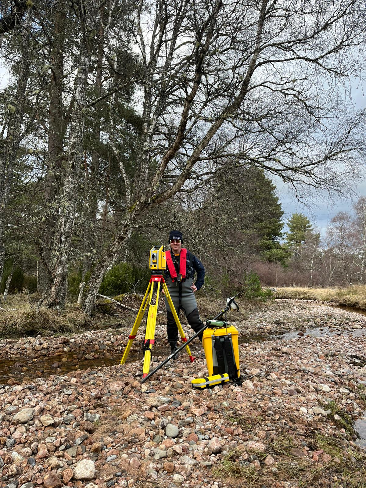 Craig operating total station on Allt Lorgy river survey (2024)