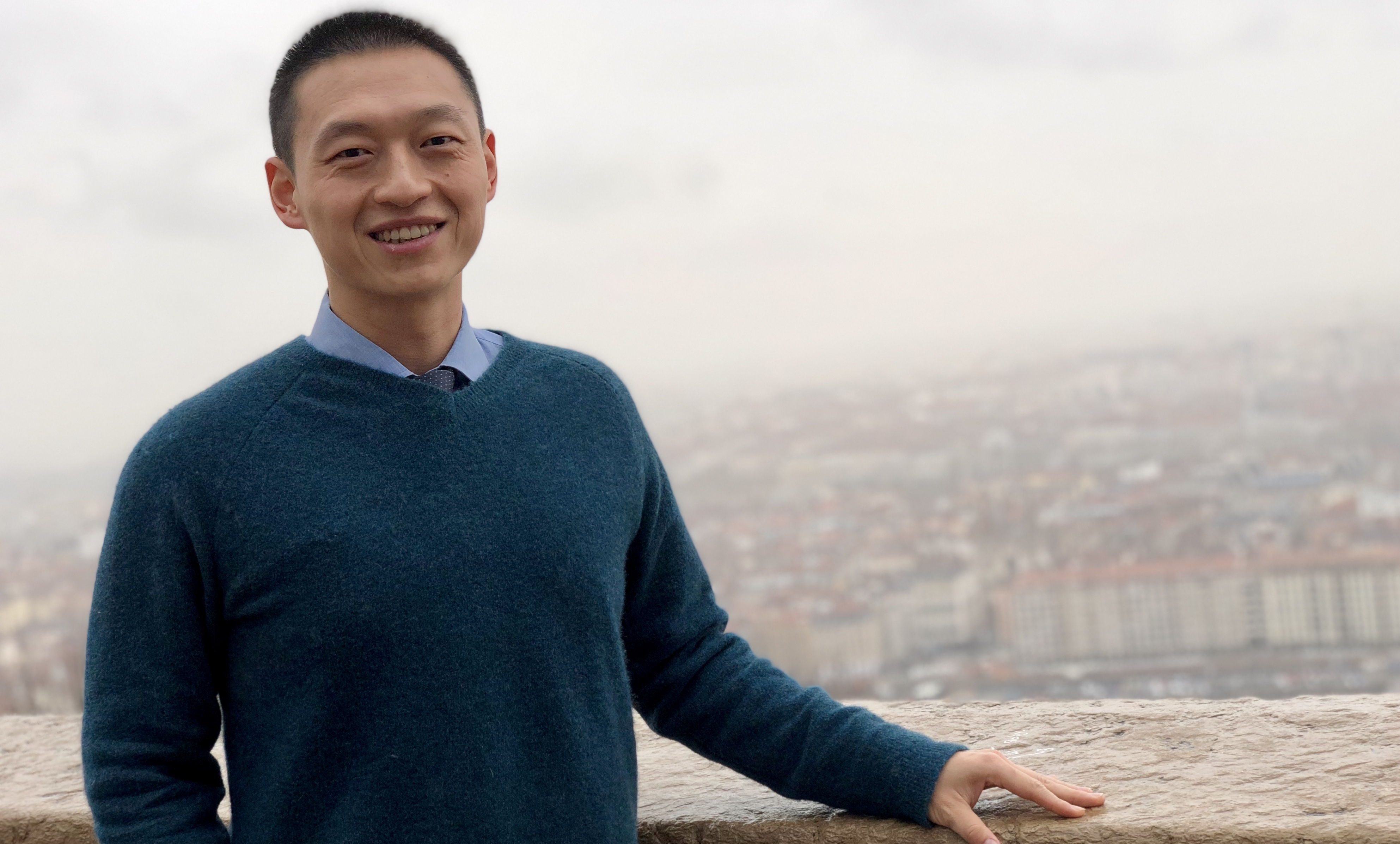 Portrait of a man with a city panorama behind him