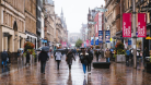 A rainy photo of people walking on Buchanan Street in Glasgow city centre