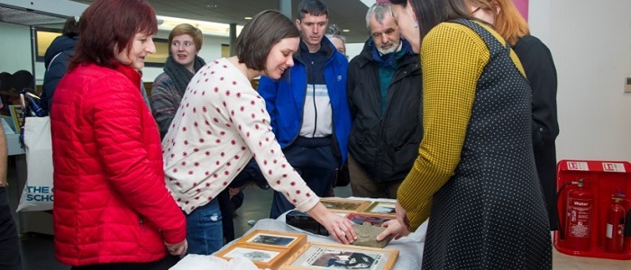 People interacting with art around a table