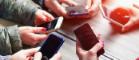 photo of young peoples hands with mobile phones cropped 