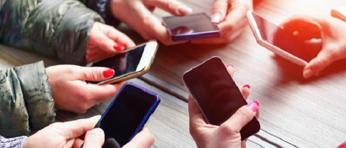 photo of young peoples hands with mobile phones cropped