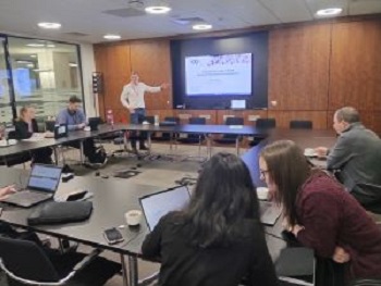 photo of a room of people with a lecturer at the front