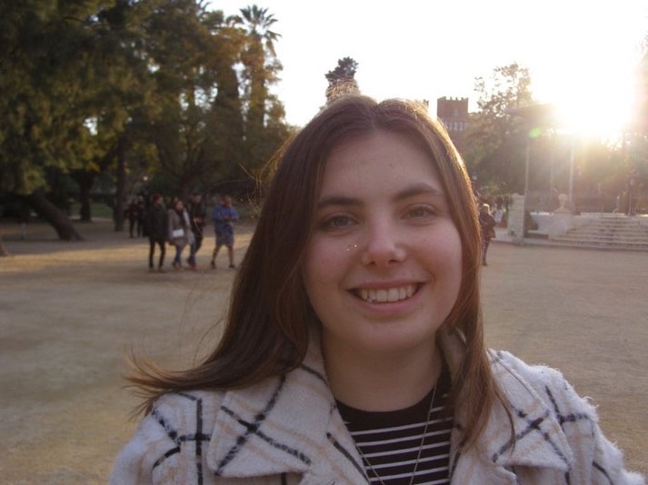 Laura smiling in a park.