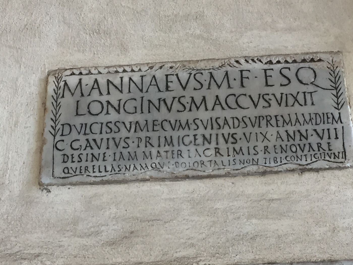 Epitaph (first century AD) of the actor M. Annaeus Longinus, of the Esquiline tribe, who played the role of the Atellane character Maccus “Mr Stupid”. It was discovered in the catacombs of SS Gordianus and Epimachus in Rome, and is now placed in the walls of the portico of Santa Maria in Trastevere, Rome (CIL 6.10105 = ILS 5219 = CLE 823) (photograph taken by C. Panayotakis).