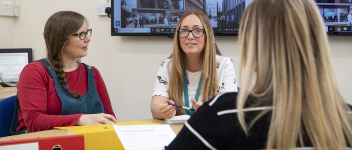 picture of 3 female staff in meeting room