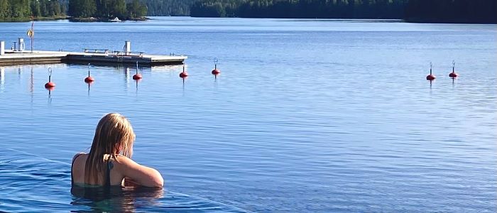 Photo of Enni Miller swimming in a lake in Finland
