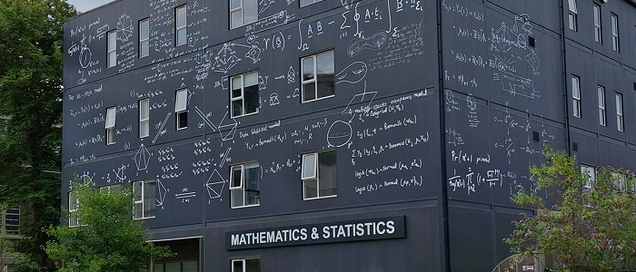 The outside of the Maths and stats building which has equations drawn all over the walls