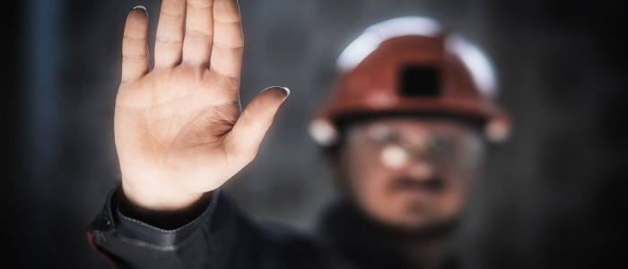 A miner holds his hand up