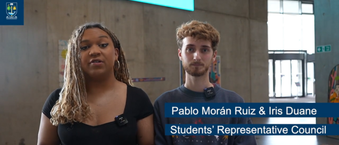 Iris Duane and Pablo Moran Ruiz of the Students' Representative Council standing in front of the Together Against Gender-Based Violence art installation at the JMS