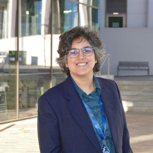 Durga Nagarajan standing for profile photo outside the Adam Smith Building, University of Glasgow