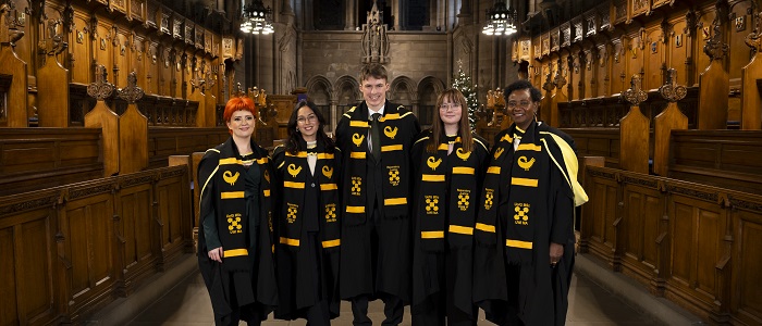 L to R Reparatory Justice Masters graduates Nicole Whyte; Fer Ortiz Vivas, Fergal O’Donohoe;  Fanny Olsson and  Cordelia Asamoah standing in their graduation gowns in the University of Glasgow Chapel. Credit Martin Shields