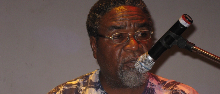 Prof Kofi Anyidoho speaking into a microphone