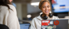 A student smiling while looking at their laptop