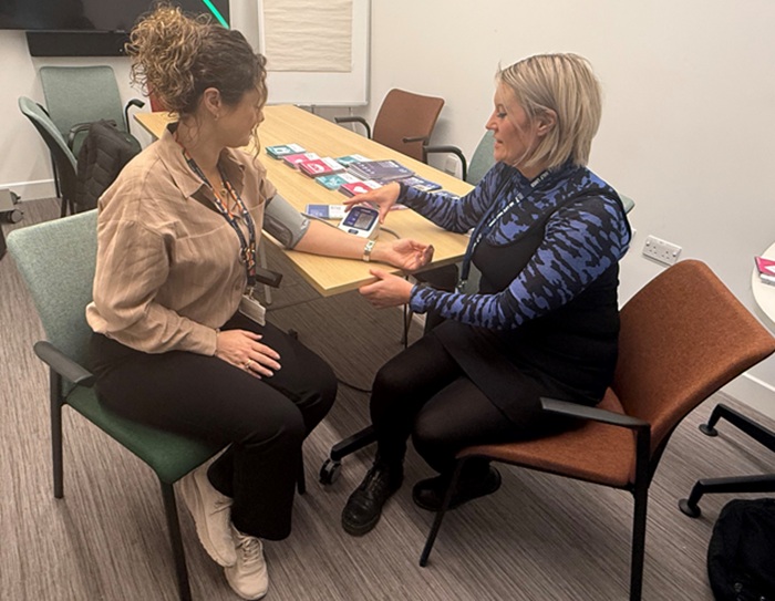 Susan Grant is getting her blood pressure checked by a nurse