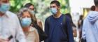 People walking outside wearing blue masks to protect them from Covid-19