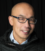 A head and shoulders portrait shot of Professor Gwo-tzer Ho