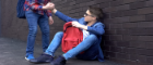 A teenager gives a helping hand to a peer.