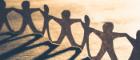 Paper chain of human figures and their shadows