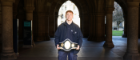 A student intern posing in the cloisters with his championship belt