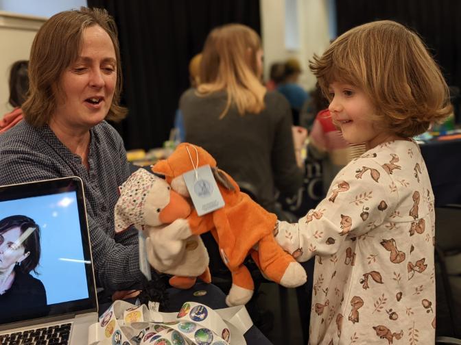 Child playing with a puppet