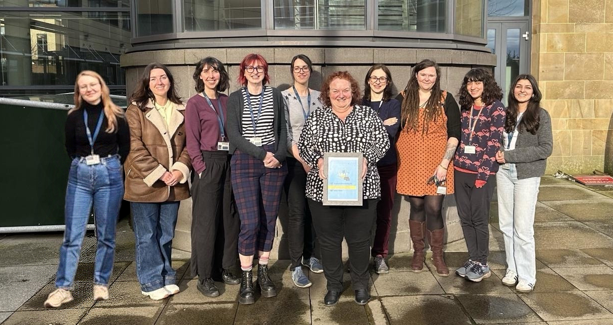 The members of the Sii ECO Group committee stood outside the SGDB with Jen Barrie holding their Gold LEAF Certificate