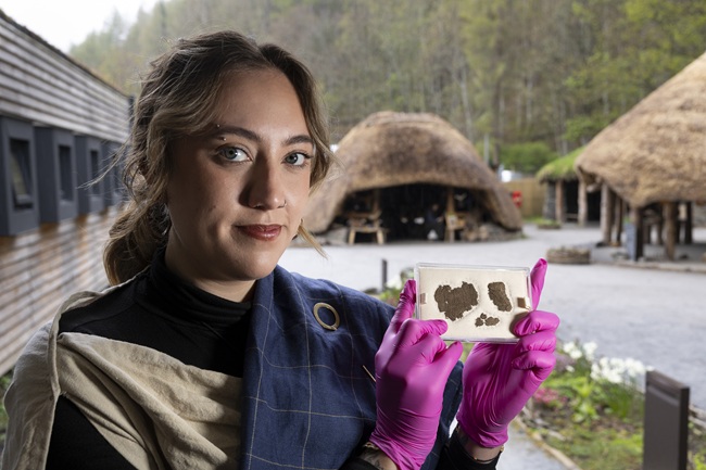 Experimental archaeologist Isobelle Hanby with the piece of woven fabric. Photo Martin Shields