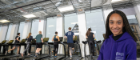 People running on a treadmill in the gym with headshot of smiling woman